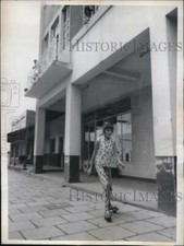 1963 Press Photo A young girl skates along the empty streets of Jadotville