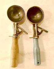 Lot Of Two Vintage Ice Cream Scoops One Has A Wooden Handle On It