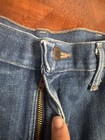 Wrangler jeans size 36x30 with orange stitching, front zipper, and round button closure made in USA.