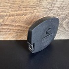 Black vintage Stanley 50 foot hand crank tape measure with white printed brand and dimensions, made in USA.