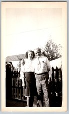 Vtg B&W Snapshot Smiling Couple Man in Tie Woman in Skirt By Fence 1940s