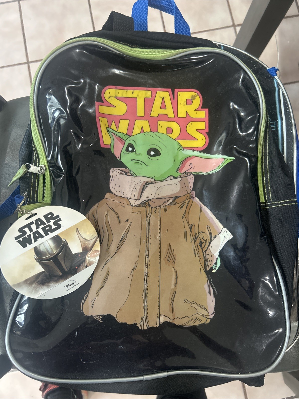 The image shows a child's backpack featuring characters from the Star Wars