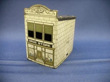 ANTIQUE TIN VILLAGE DRUG STORE TOY CANDY CONTAINER, CIRCA 1914