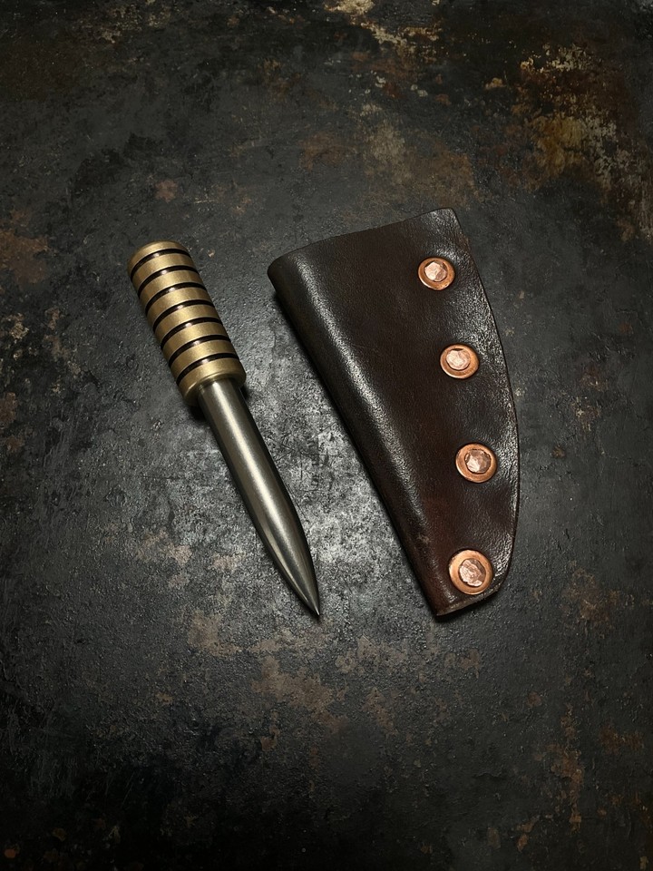A handcrafted titanium-and-brass marlin spike awl — the kind of beautifully overengineered pocket tool that EDC obsessives lose sleep over.