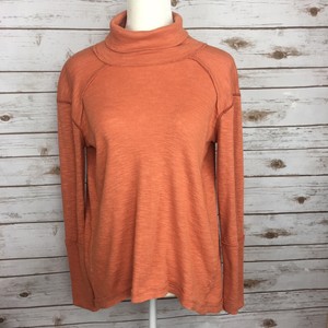 orange turtleneck top