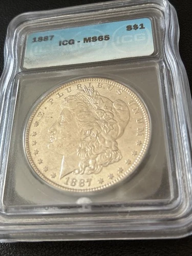 1887 Morgan Silver Dollar. ICG MS65. Valued At $235.