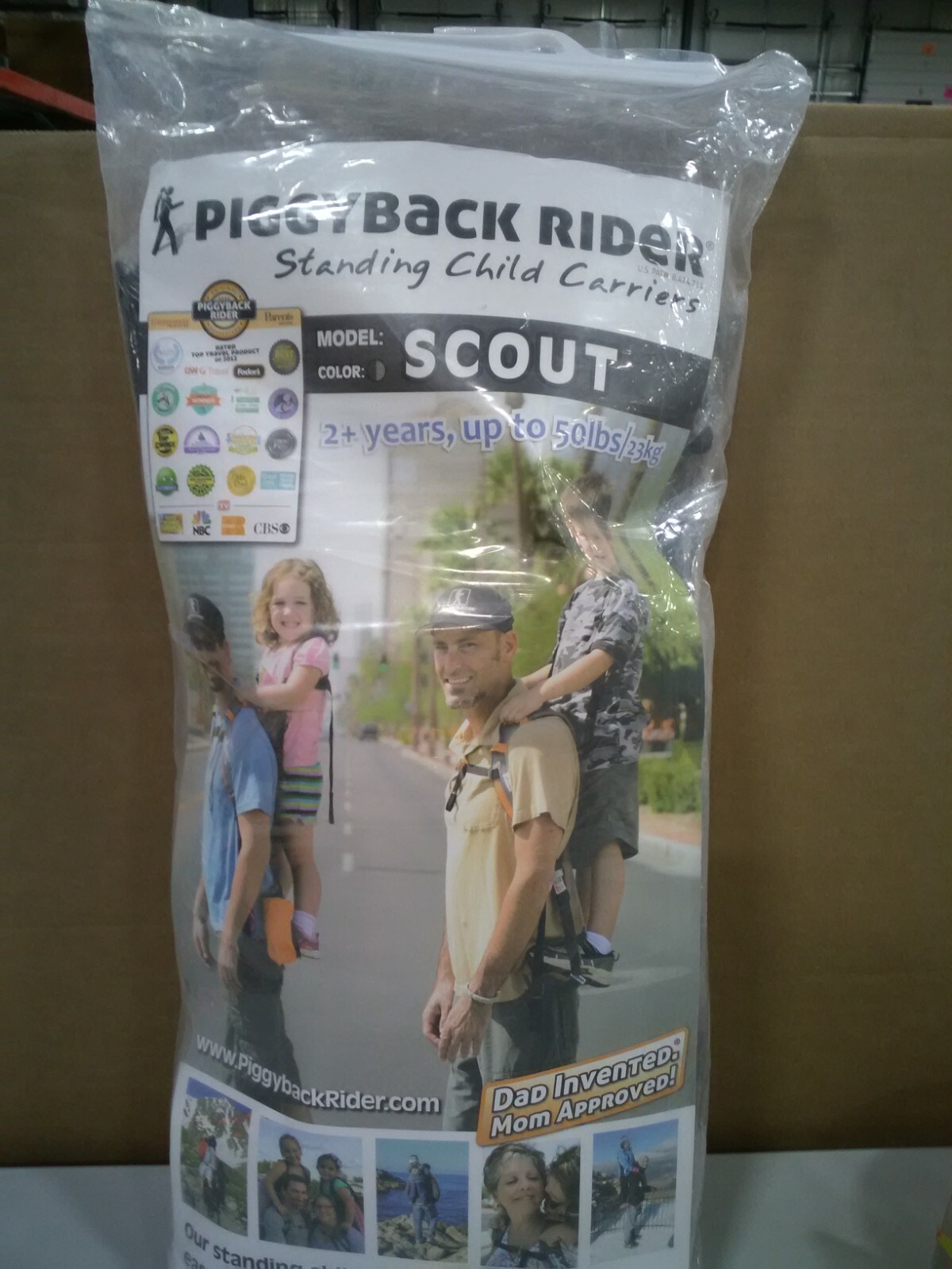 child standing back carrier