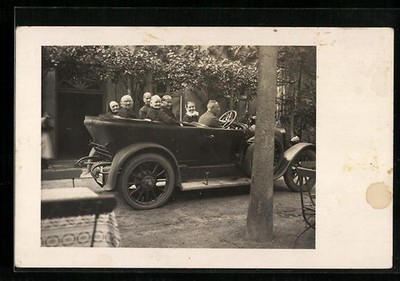 Photo postcard car with driver and old women on the road 