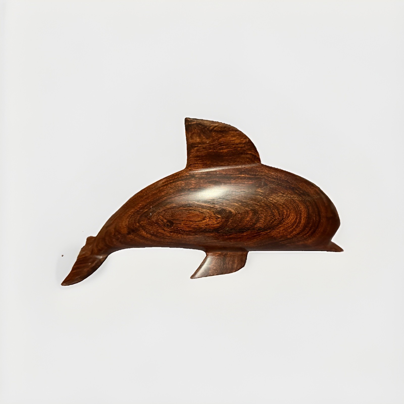 Carved wood dolphin figurine with smooth polished finish.