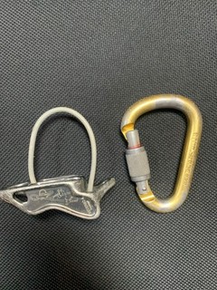 Petzl Reverso 4 belay device and Attache locking carabiner. Climbing hardware.