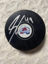 autographed Samuel Girard avalanche team puck with proof photo 