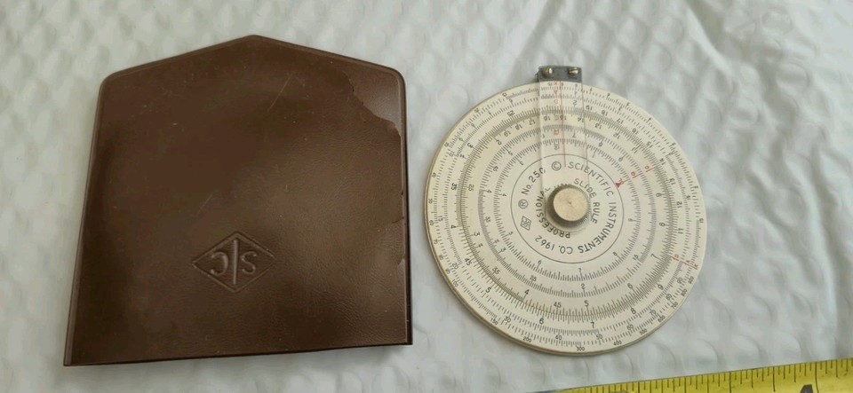 A 1962 professional circular slide rule — a gorgeous analog computing relic that looks like a prop from a Cold War NASA mission.
