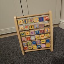Woodlets Alphabet Abacus, a double-sided wooden learning toy.