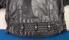 Black vintage leather Langlitz motorcycle jacket with quilted back panel, button front, and two zippered pockets.
