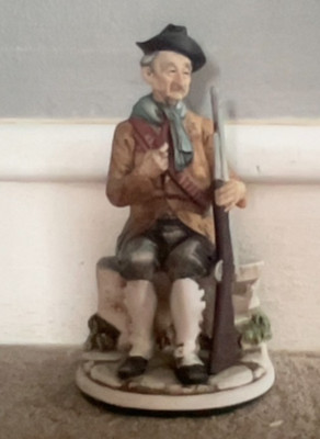 Vintage Ceramic FIgurine. Man With A Pipe & Gun. 9'' Tall. Felt Bottom.