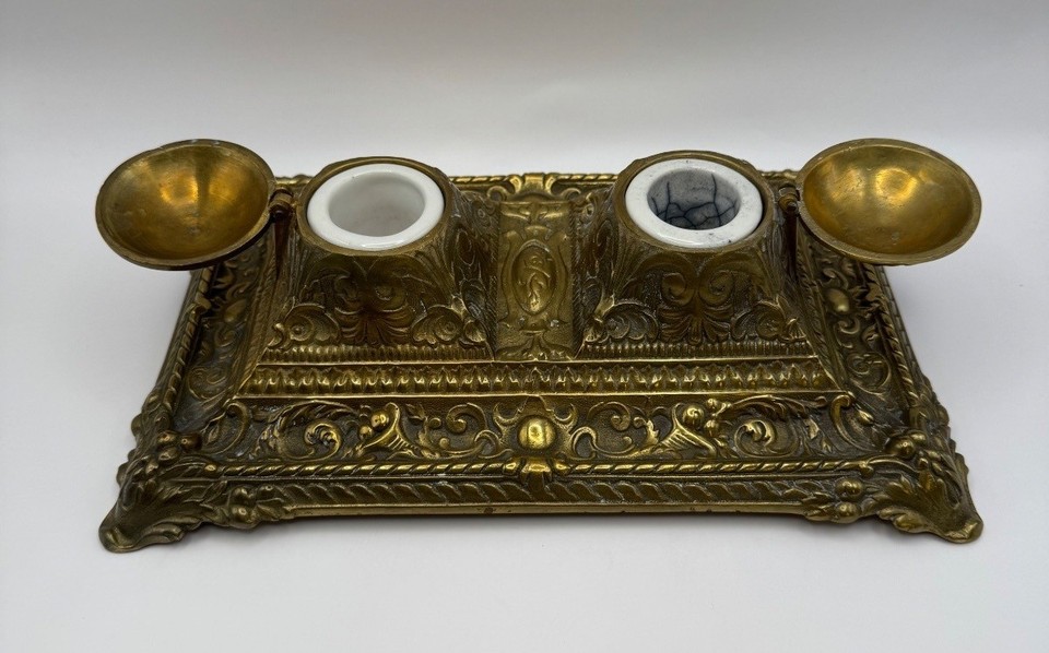 A genuine antique French brass inkwell set with porcelain inserts and a 'Déposé' maker's mark — museum-quality desk art that's actually usable.