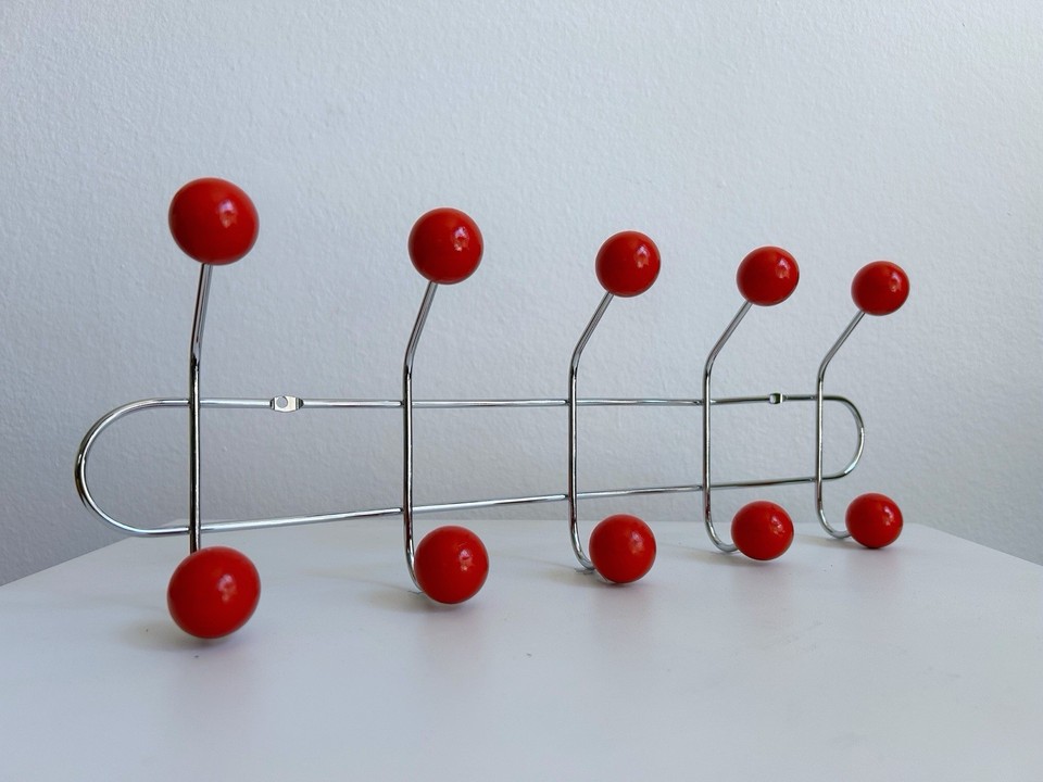 A coat rack that doubles as sculptural wall art — clean MCM lines mean it earns its spot even when it's not holding coats.
