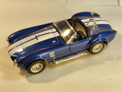 Kinsmart 1965 Shelby Cobra 427 S/C. 1:32 scale. New. Doors open. Bl-wht stripes.
