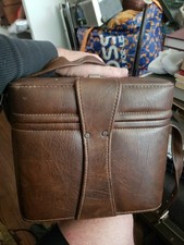 vintage brown leather camera bag featuring a hard shell Carry