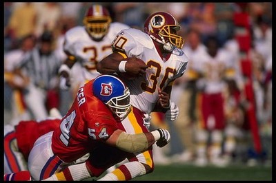 Running back Brian Mitchell Washington Redskins is tackled by Denv- 1995 Photo