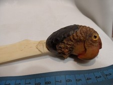 ANTIQUE CARVED COQILLA NUT PARROTS HEAD WITH GLASS EYES.