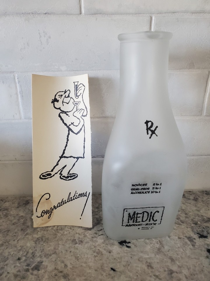 A vintage glass cocktail mixer shaped like a urinal — functional barware that doubles as an instant conversation starter at any party.