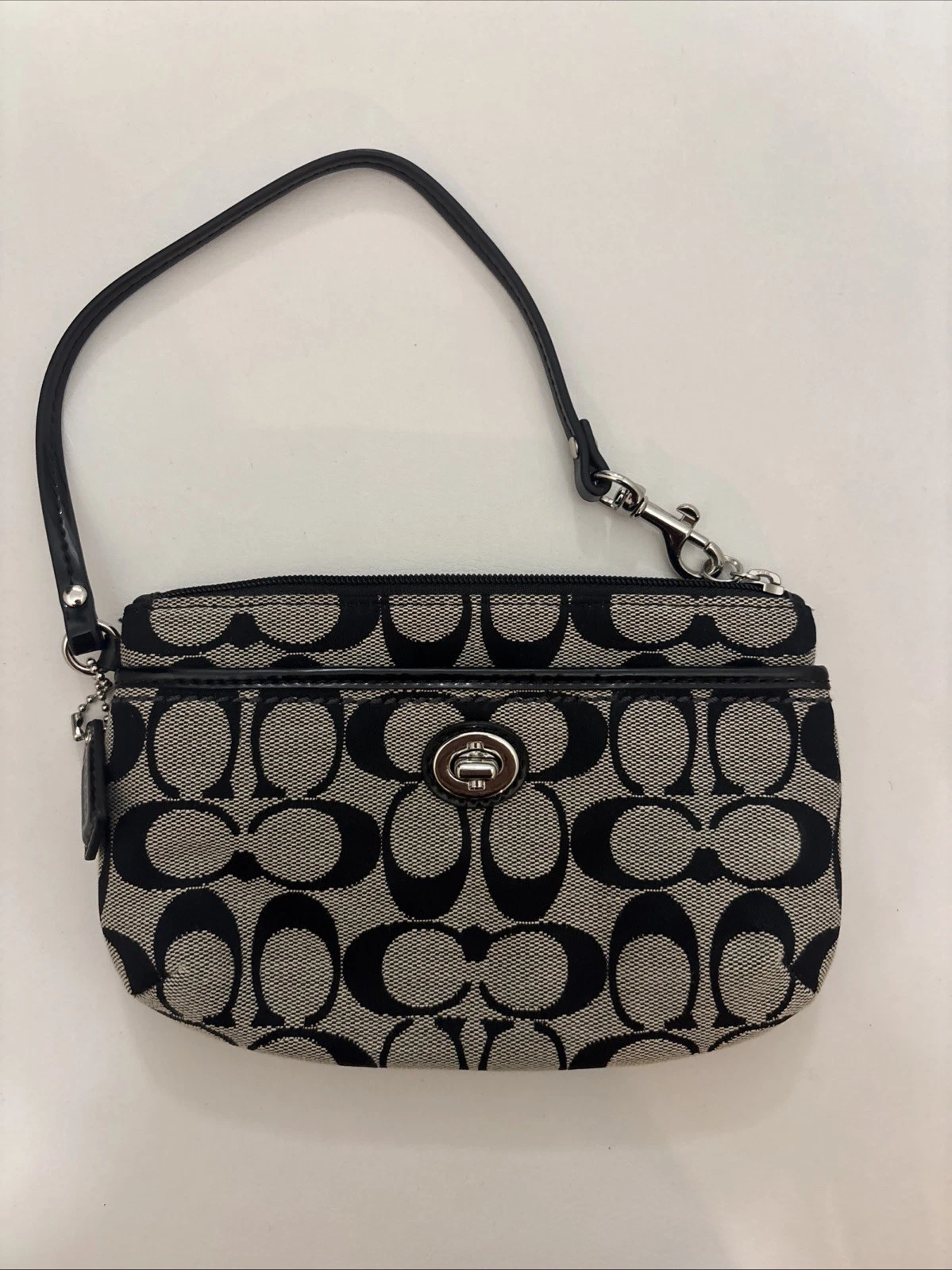 Portafoglio da polso COACH Signature in tela marrone nero con zip