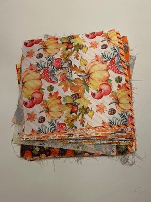A stack of 100% cotton quilting fabric featuring a fall-themed ''Pumpkin'' ect