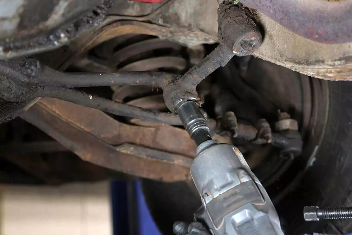 An impact gun removes the idler arm’s castle nut.