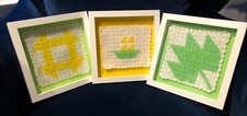 Set of three green and yellow vintage crocheted quilt squares In white frames