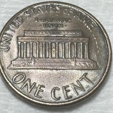 1987 D Penny With part Of America And FG missing or erased by grease.