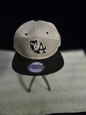Two-tone gray and black snapback hat features...