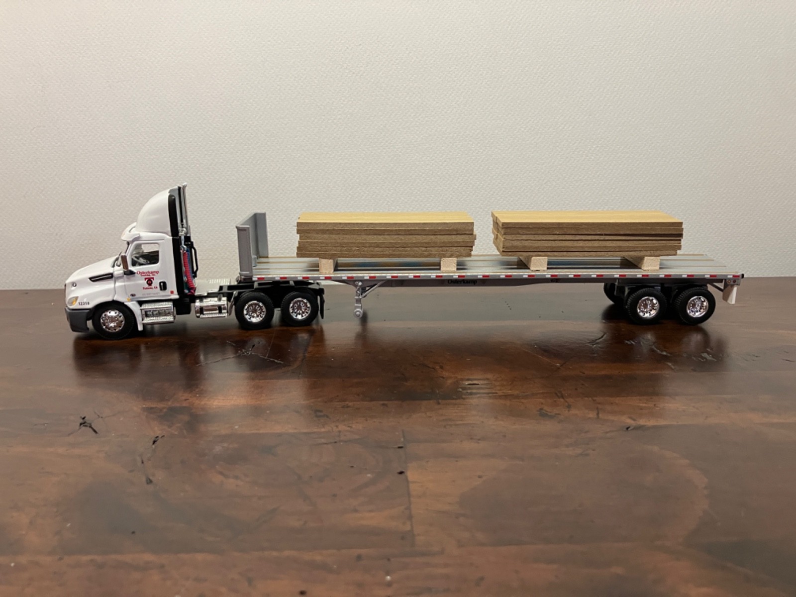 DCP First Gear 1/64th Osterkamp Trucking Cascadia Day Cab and 45' Flatbed w/load