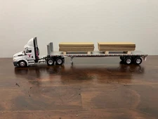 DCP First Gear 1/64th Osterkamp Trucking Cascadia Day Cab and 45' Flatbed w/load