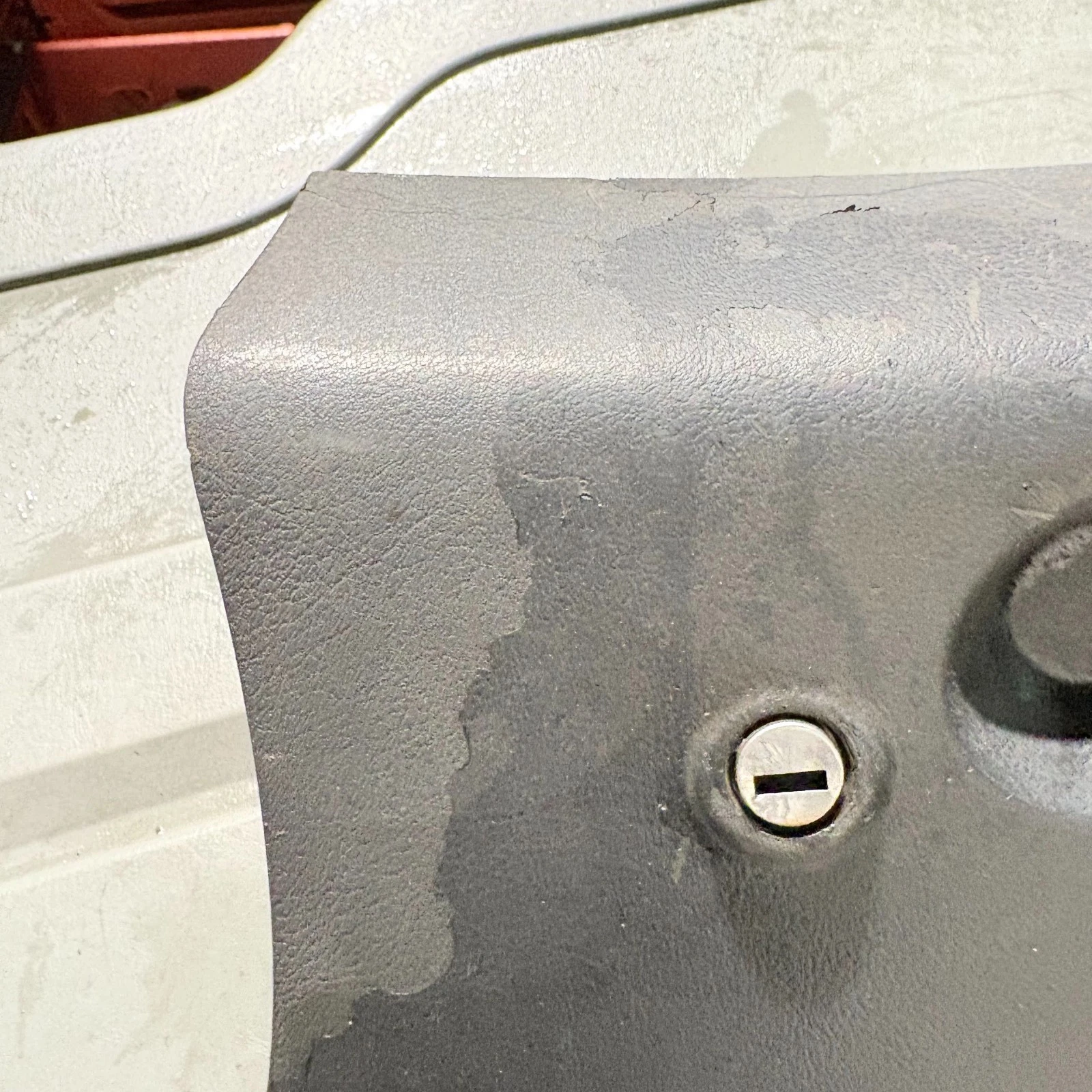 Close view of glove box lock and surface wear