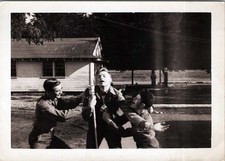 WW2 Photo of Two Soldiers Talking Between Barracks Buildings