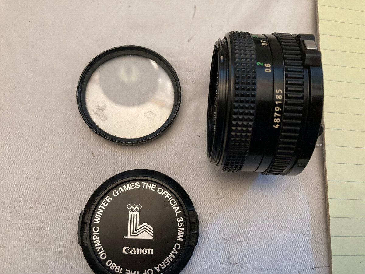 Canon Lens FD 50mm 1:1.8 lens cover and 52mm skylight filter Canon Lens FD 50mm 1:1.8 lens cover and 52mm skylight filter