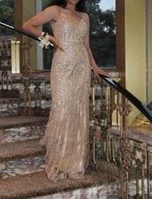 Gold, embellished, floor-length formal dress with a layered train. Worn only...