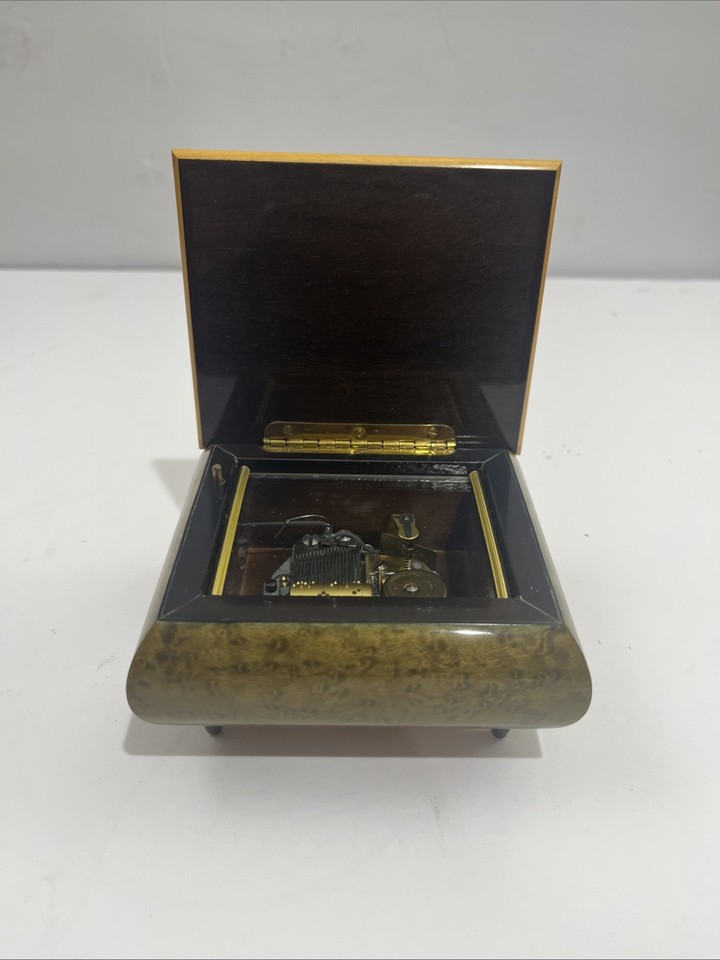A higher-end Reuge Swiss music box — one of the most respected mechanical music makers in the world, fully working.