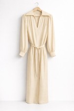 A cream silk Tory Burch long-sleeved tunic dress with a tie belt.