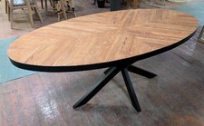 Oval dining table with double-cross steel base