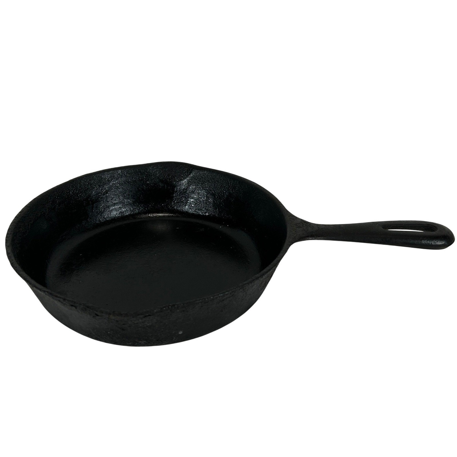 Cast iron skillet with two pour spouts on a white background