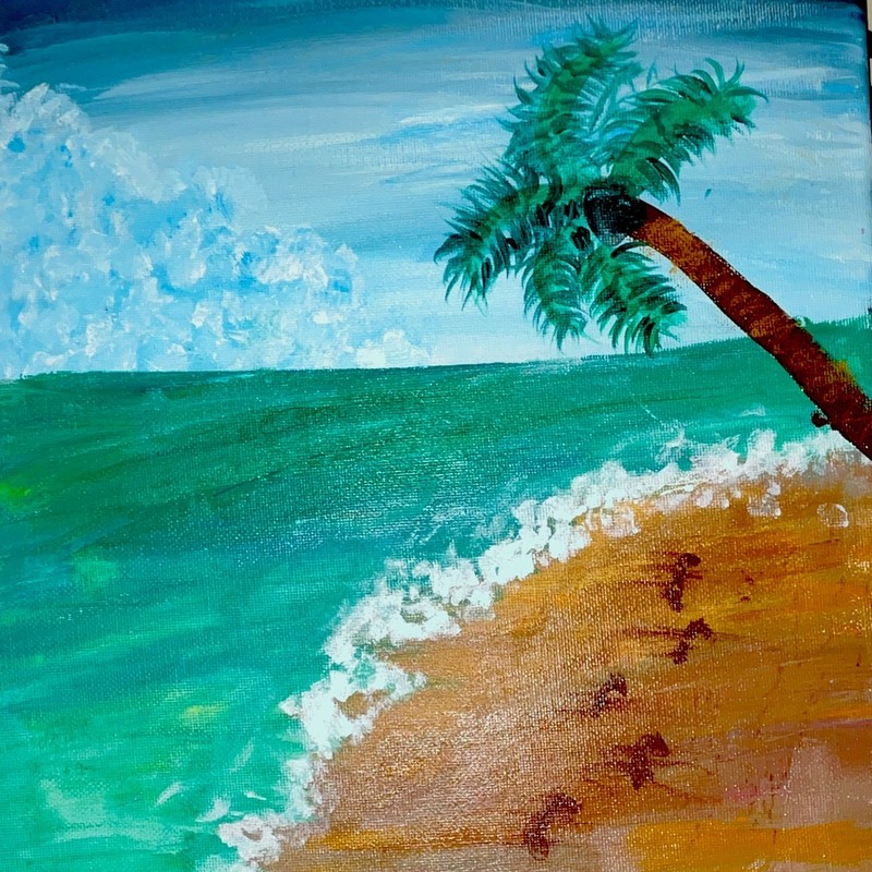 peaceful tropical atmosphere with a lone palm tree, rolling waves, and footprint