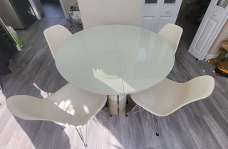 Glass top extending dinning table 1.1m round 1.5m extended in an oval shape
