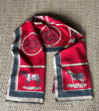Elegant red patterned scarf featuring an equestrian-inspired motif