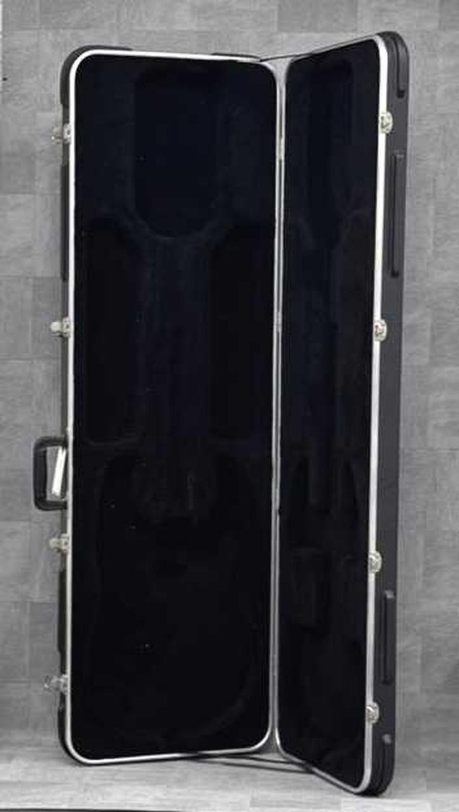 Black ERNIE BALL MUSICMAN STINGRAY used ash body guitar with maple neck and hard shell case.