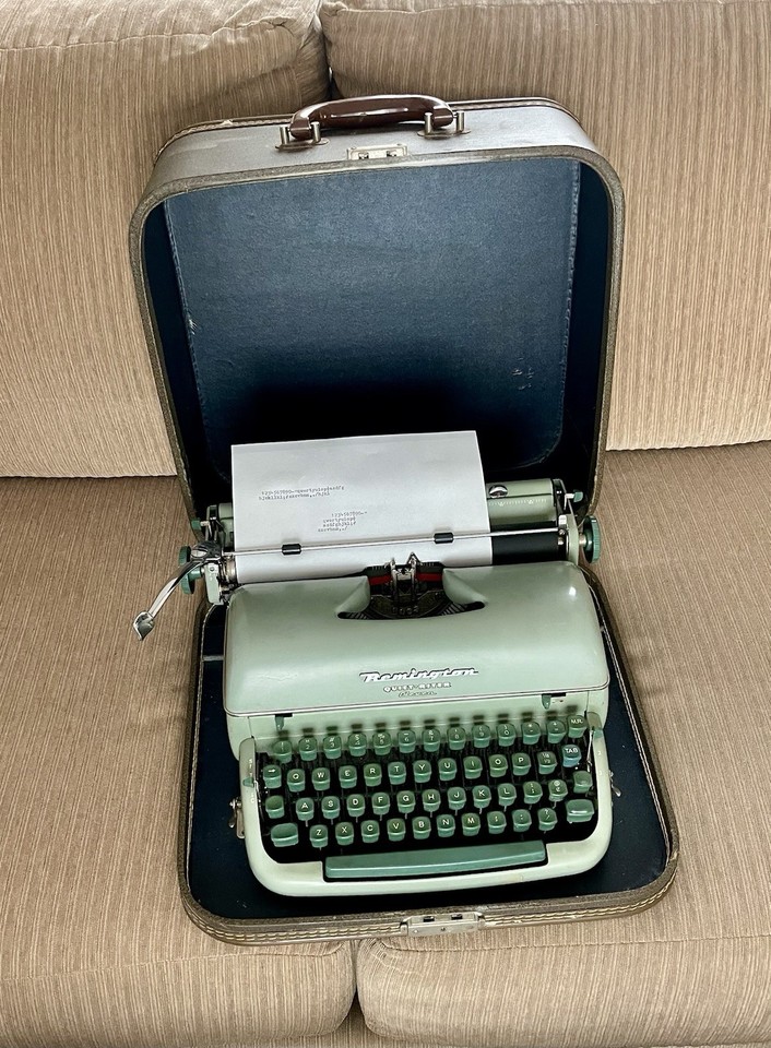 A Remington Quiet-Riter in a distinctive green finish with its original case — the 'Miracle Tab' feature alone is a delightful vintage quirk.