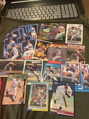 Collection of 24 Greg Maddux baseball cards.