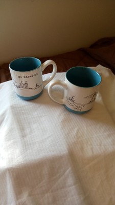 2 Sheffield ''Go barefoot'' black graphics beach scenes, ocean blue mugs