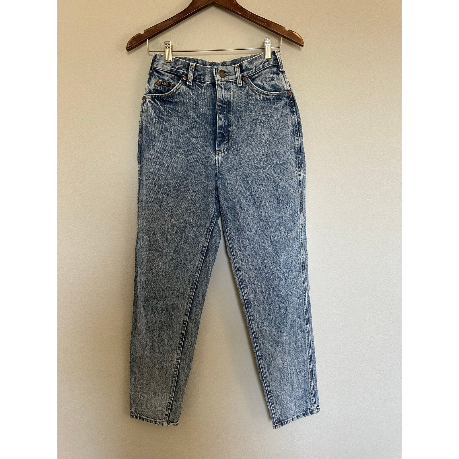 Light blue vintage Lee High Rise Mom Jeans size 8 with faded front thighs, five-pocket design, and visible “Made in USA” label.